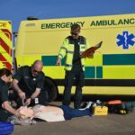 AMG Trainer instructing two medics reviewing ILS procedures